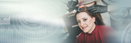 Hairdresser coloring female client hair; panoramic bannerの写真素材