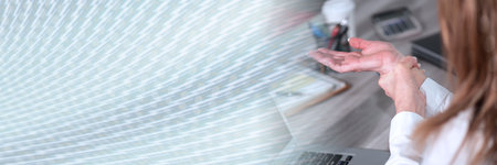 Businesswoman suffering from wrist pain; panoramic bannerの写真素材
