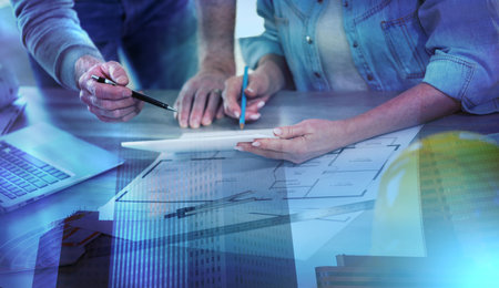 Architects working on new construction project and using digital tablet; light effect; multiple exposureの写真素材