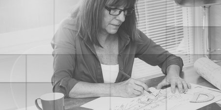 Architect working on plans at office, light effect, geometric patternの写真素材