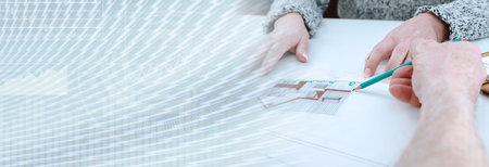 Architect showing house plans to his client; panoramic banner