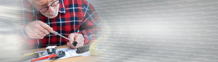 Senior electrician connecting wires in terminal block; panoramic bannerの写真素材