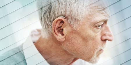 Senior man wearing hearing aid, geometric patternの写真素材