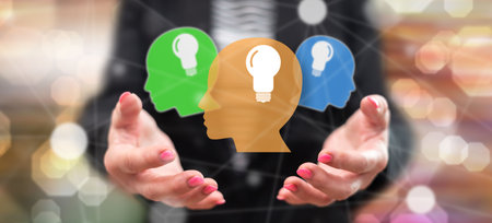 Human brain ideas concept above the hands of a woman in background