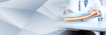 Doctor holding files in his office; panoramic bannerの写真素材