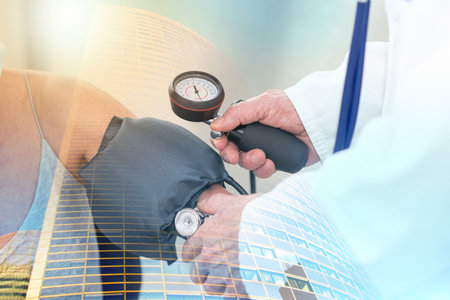 Doctor measuring blood pressure of a female patient; multiple exposure