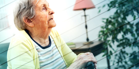 Portrait of an elderly woman sitting with her hands on a cane, geometric pattern