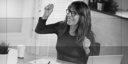 Mature businesswoman with arms up; business success, geometric patternの写真素材