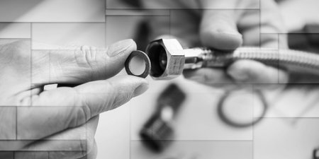 Plumber putting a gasket on a plumbing fitting, geometric patternの写真素材