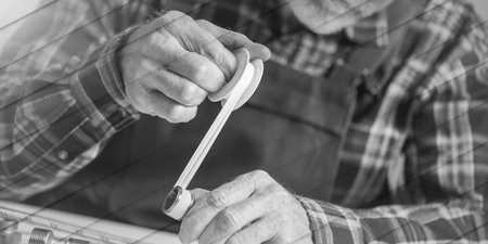 Plumber putting seal tape on a thread of a plumbing fitting, light effect, geometric patternの写真素材