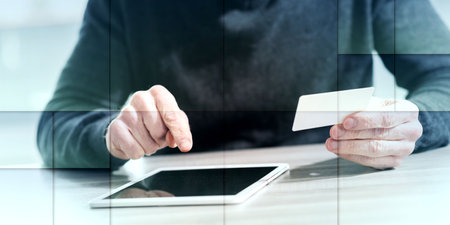 Man using his credit card for online payment, geometric pattern