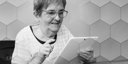 Senior woman using a tablet, geometric patternの写真素材