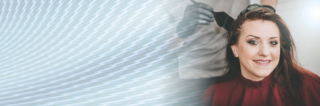Hairdresser coloring female client hair; panoramic bannerの写真素材