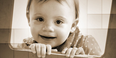 Cute baby girl having fun on a playground and looking at the camera, geometric patternの写真素材