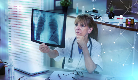 Female doctor looking at x-ray in medical office; light effect