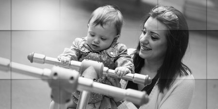 Baby girl having fun on a playground with her young mother, geometric patternの写真素材