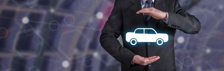 Car insurance concept with businessman in a protective gestureの写真素材