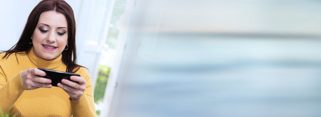 young businesswoman using her mobile phone; panoramic bannerの写真素材