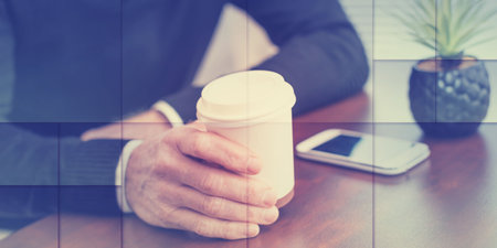 Man having coffee break at home, geometric patternの写真素材