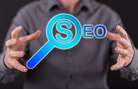 SEO concept between hands of a man in background