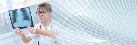 Female doctor looking at x-ray in clinic; panoramic banner