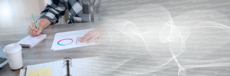 Businesswoman analyzing marketing data and taking notes; panoramic banner
