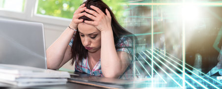 Overworked young businesswoman sitting in front of laptop; multiple exposure