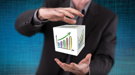 Financial growth concept between hands of a man in backgroundの写真素材