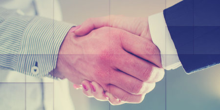 Handshake between business people, geometric patternの写真素材