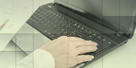 Businesswoman working on financial graphs at the office, geometric patternの写真素材