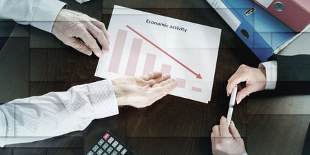 Businessman showing graph falling down, geometric patternの写真素材