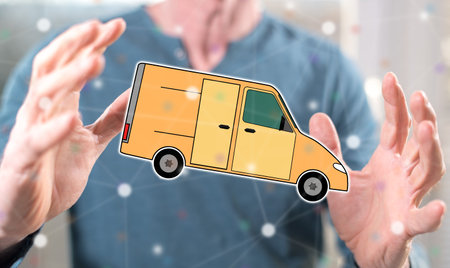 Delivery concept between hands of a man in backgroundの写真素材