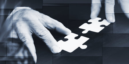 Hands joining two puzzle pieces, teamwork concept, geometric pattern