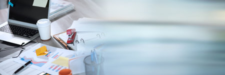 Messy and cluttered office desk; panoramic banner