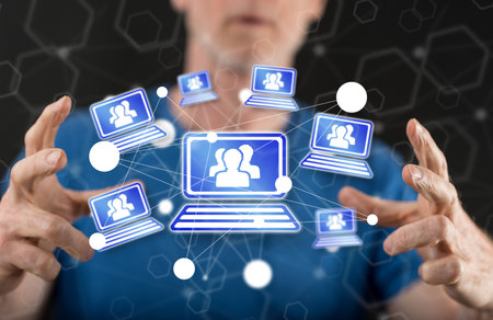 Video conference concept between hands of a man in background