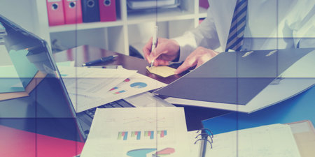 Businessman working at an untidy and cluttered desk, geometric pattern