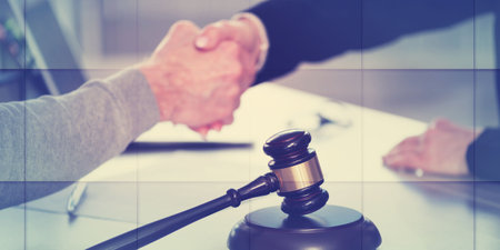 Handshake between female lawyer and male client after signing a contract, geometric patternの写真素材