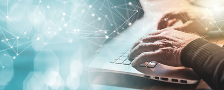 Male hands typing on laptop keyboard; panoramic banner