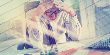 Portrait of concerned businessman sitting in office, light effect, geometric pattern