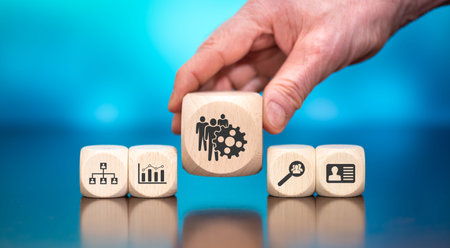 Wooden blocks with symbol of HRM concept on blue background