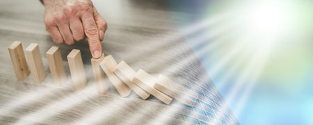 Business control concept by stopping domino effect; multiple exposure