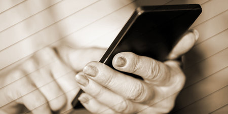 Close up of woman's hands using a mobile phone, geometric patternの写真素材