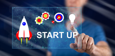 Man touching a start up concept on a touch screen with his finger