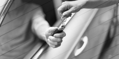 Woman holding another person automobile keys, geometric pattern