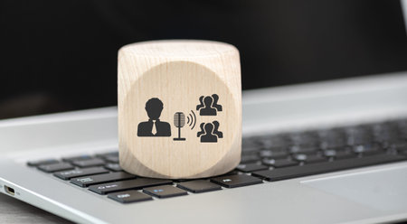 Wooden block with symbol of coaching concept on laptop keyboard