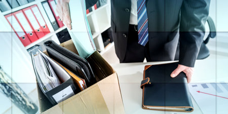 Businessman fired, putting his personal effects in a box, geometric patternの写真素材