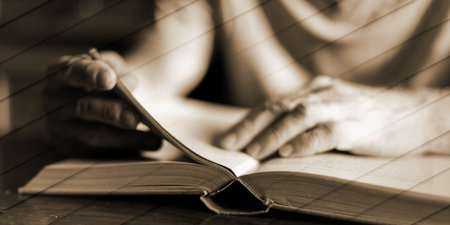 Man sitting at a table reading a book, geometric pattern