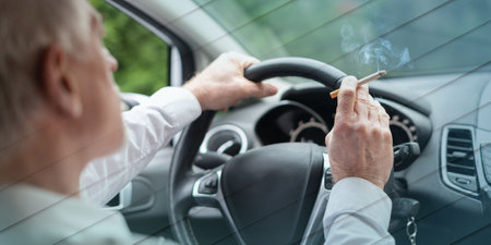 Senior man smoking a cigarette while driving, geometric pattern