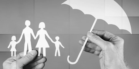 Hand holding an umbrella protecting a family, geometric patternの写真素材