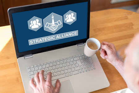Man using a laptop with strategic alliance concept on the screen
